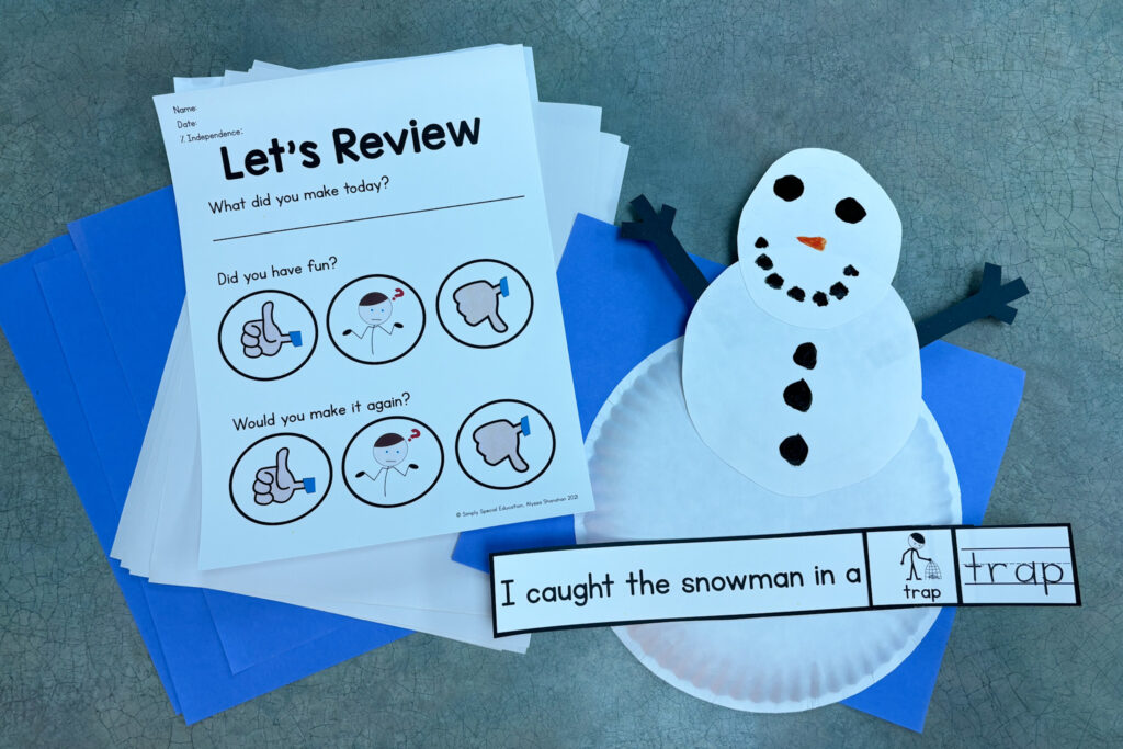 A snowman craft and a review sheet sit on a table