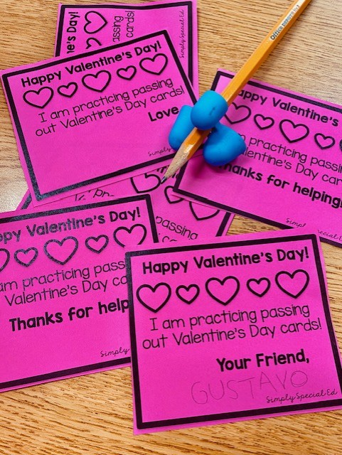 Valentine visual cards are printed on pink paper. The paper reads "Happy Valentine's Day! I am practicing passing out Valentine's Day Cards!"