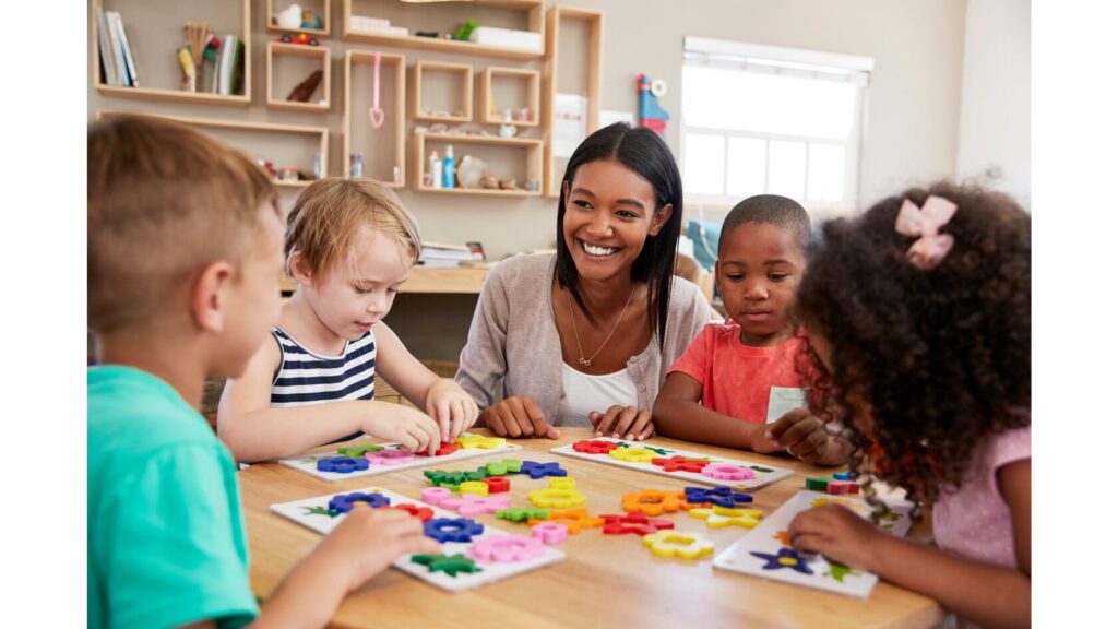Image of an adult working with a small group of 4 students.