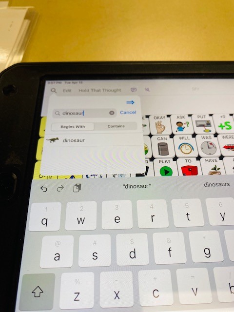 An iPad with an AAC app is shown. The search function 