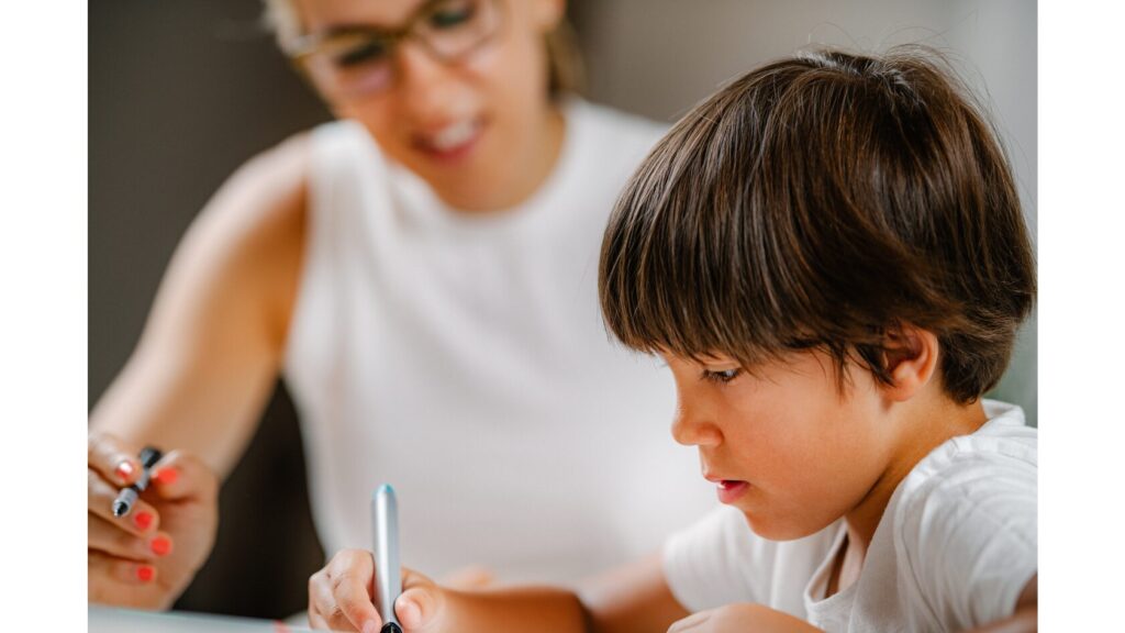 Image showing an adult working with a child.