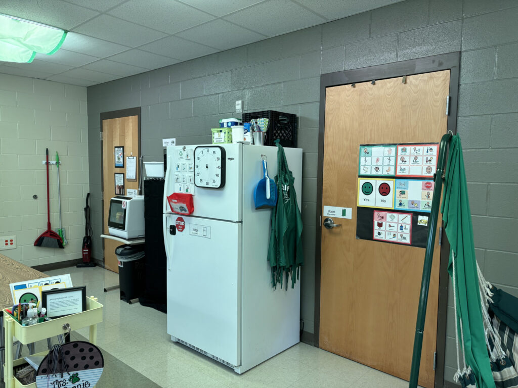 Visuals are posted on the wall near a classroom kitchen