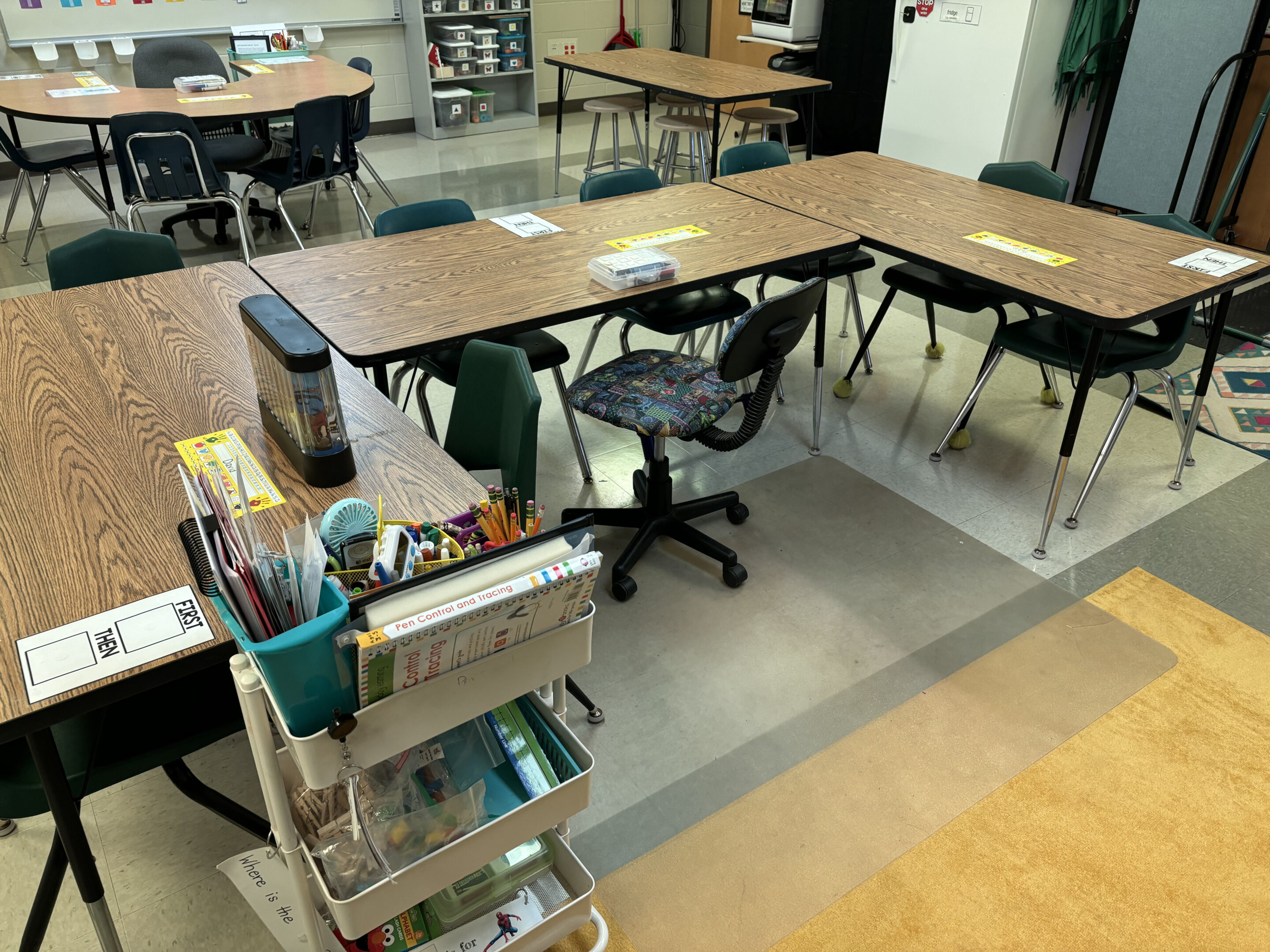 Classroom tables are pushed into an arrangement with space left around for movement