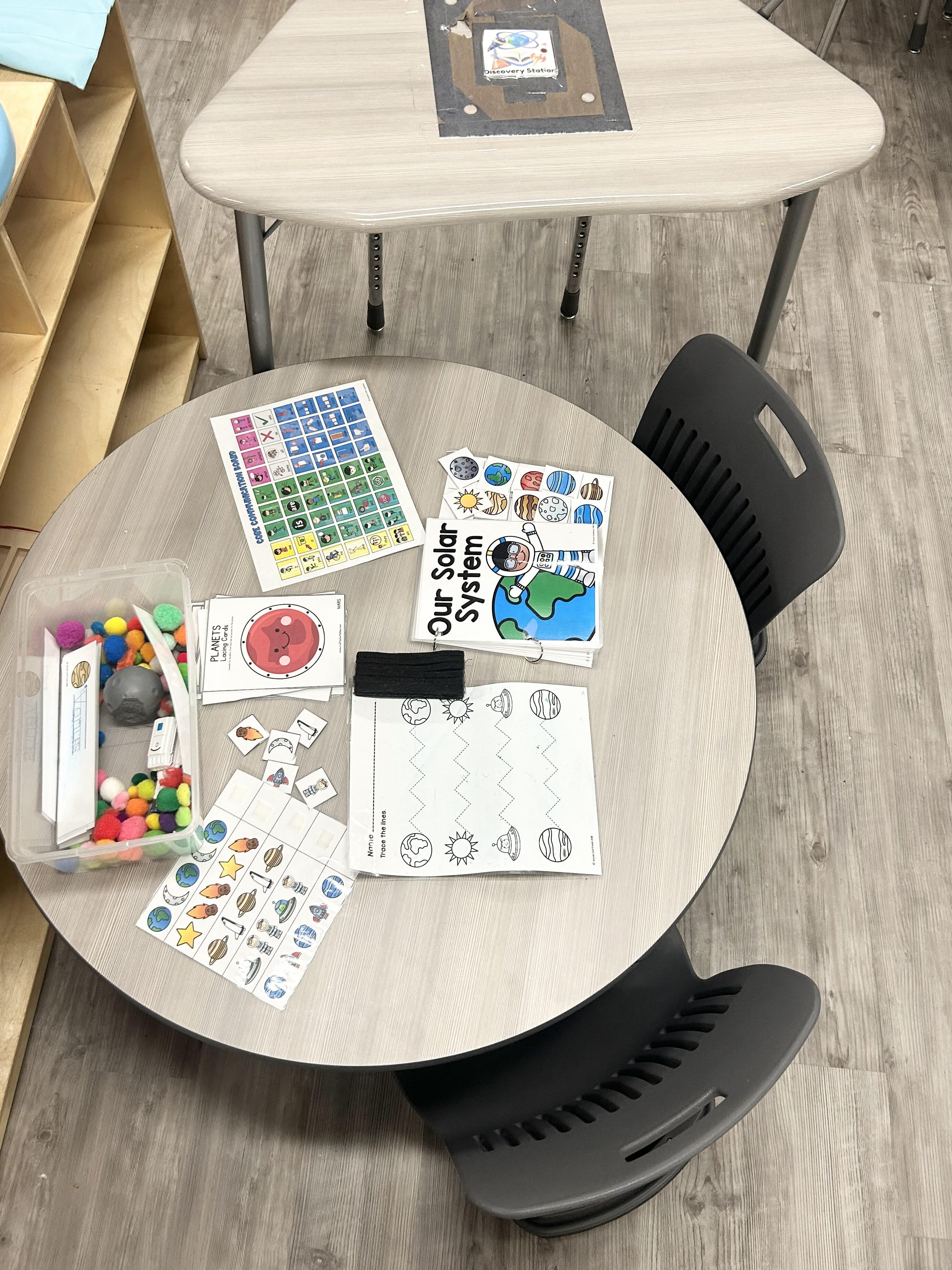 discovery station with sensory bin and space themed activities