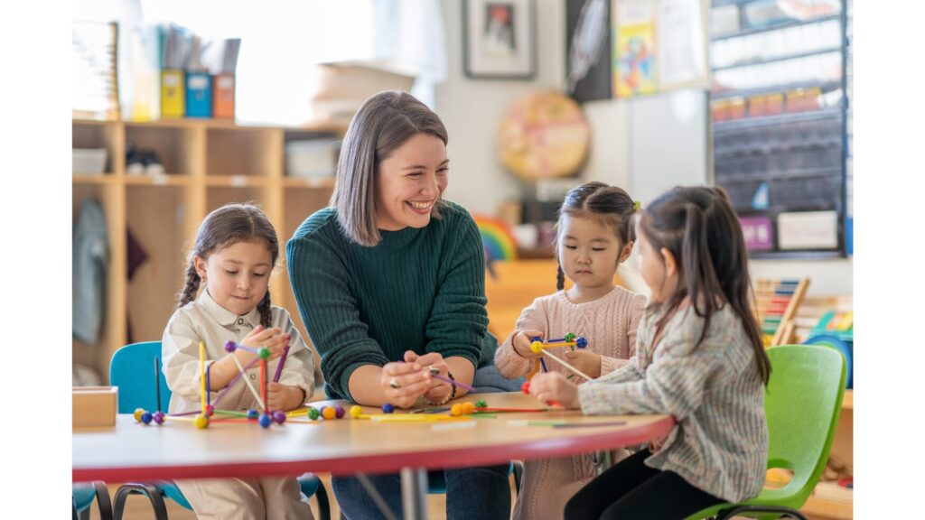 Image showing a teacher working with three students in a small group.