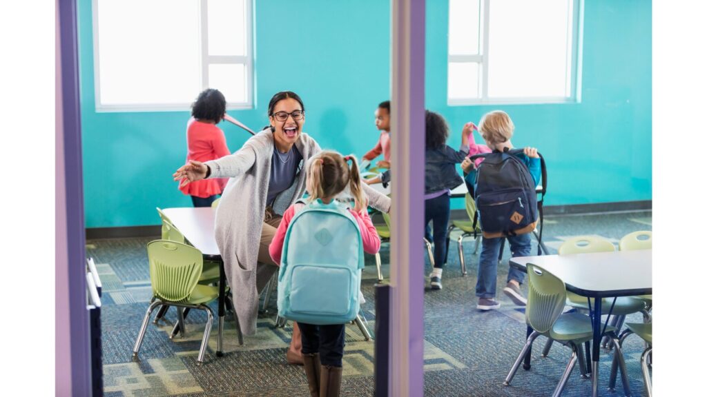 Image showing a teacher excitedly welcoming students into the classroom.