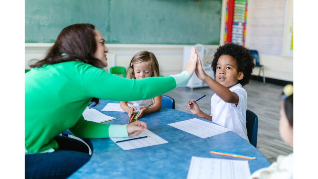 Image of a teacher giving a student a high-five.