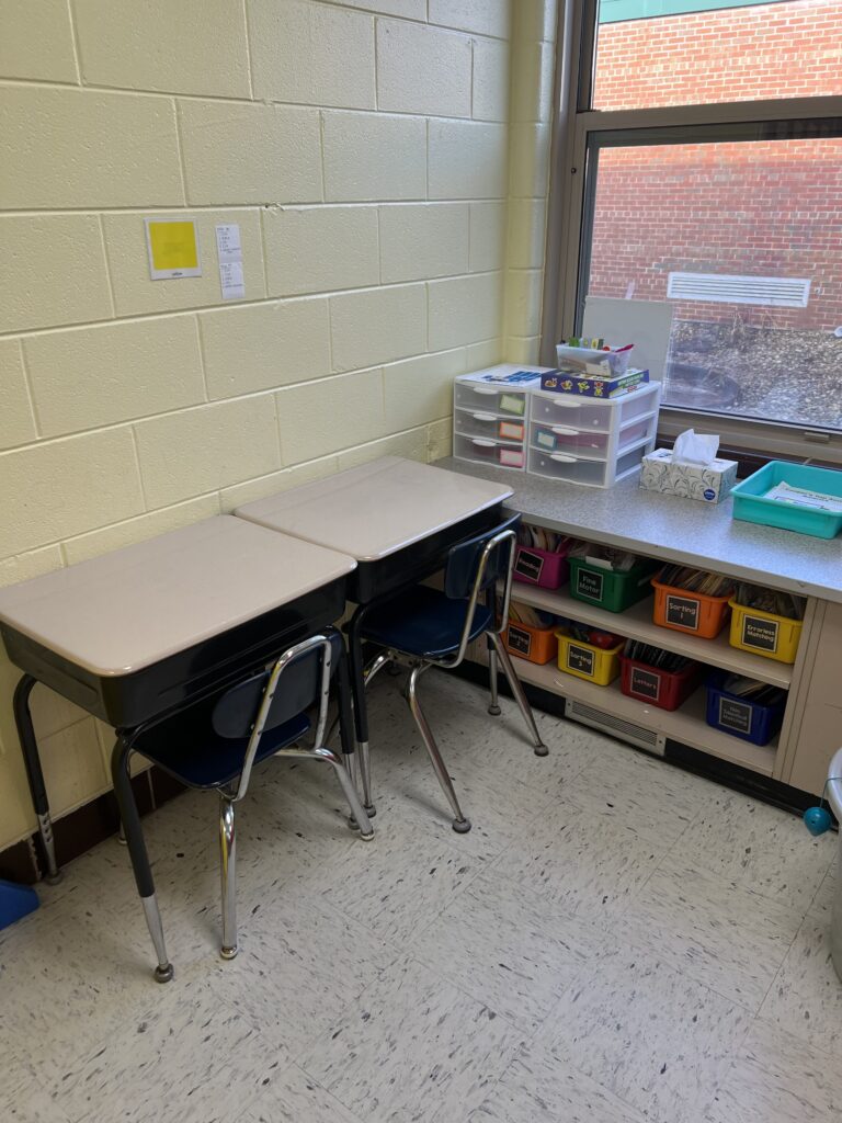 Two desks for student and paraprofessional at a center