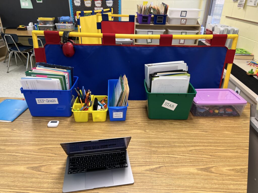 Teacher table with materials and data for IEP goals and curriculum