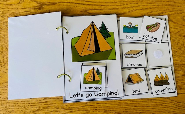 An adapted book about camping is shown open on a table, with the picture choices dispalyed.