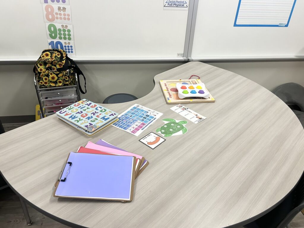 The teacher station with a round half table with academic tasks on it