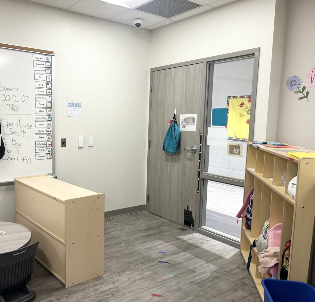 The entrance of my classroom, with a visual schedule and cubbies