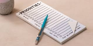 a checklist that says "priorities" at the top with a pen