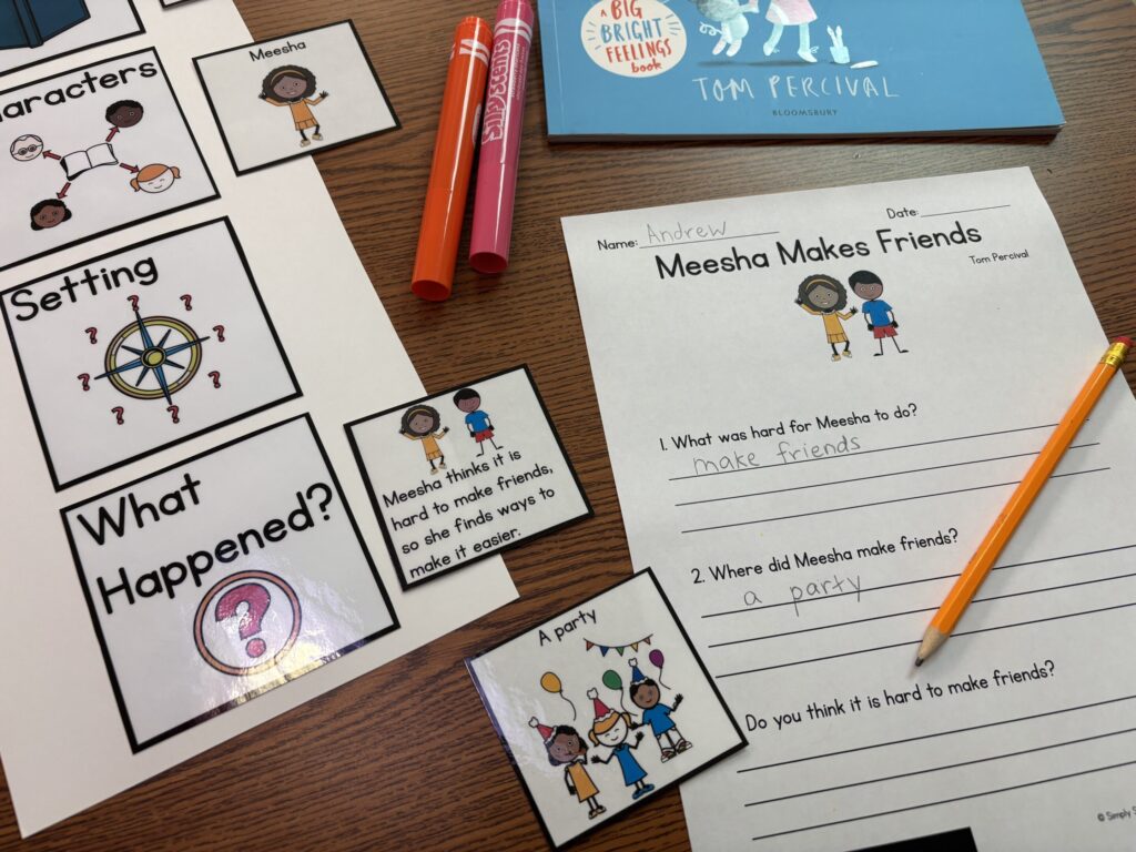 Story map cards lay on a tabletop next to a comprehension sheet with lines to write the answer. 