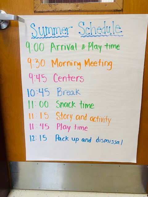 A colorful handwritten ESY schedule hanging on a classroom door
