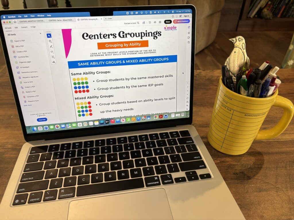 centers groupings worksheet is shown on a laptop sitting next to a coffee mug of pens