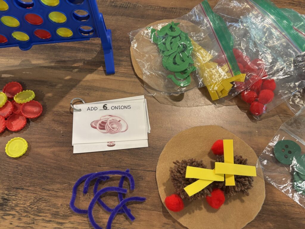 Connect Four is in the top left corner, and a felt build a taco game lays displayed on a table top