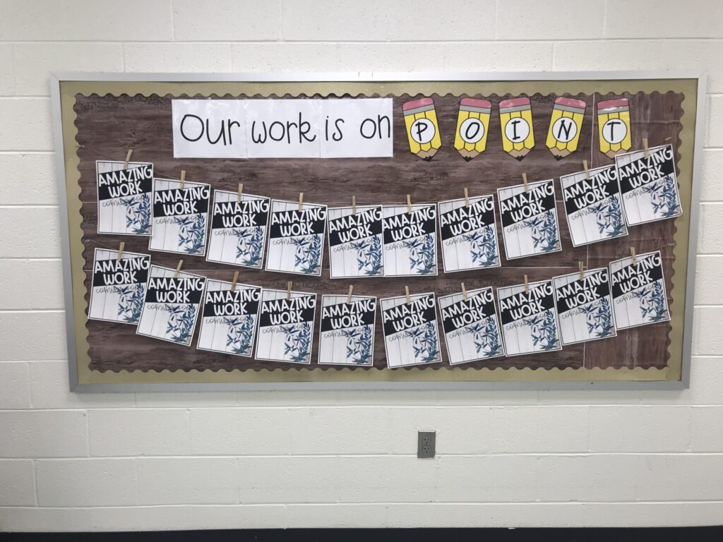 A bulletin board that says "our work is on point" with signs that say "amazing work coming soon"