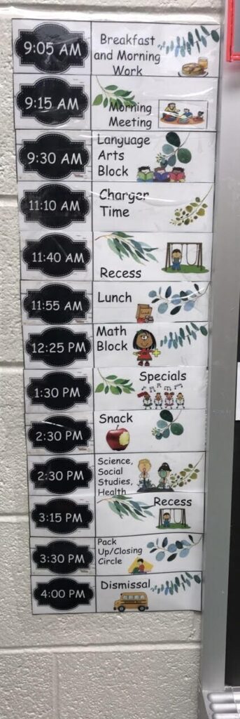 Classroom schedule posted on a wall with times of the day and activities