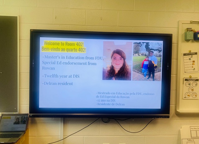 A back to school night presentation is shown on a smart board in a classroom