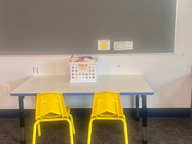 a classroom center labeled "yellow center," shows a table with two yellow chairs