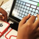 A student using an AAC device to spell the word "help"