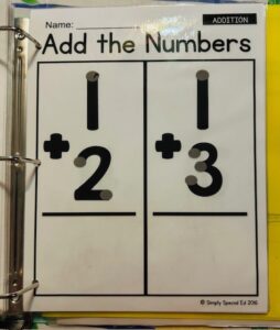 a page from the simple addition workbook showing two addition problems