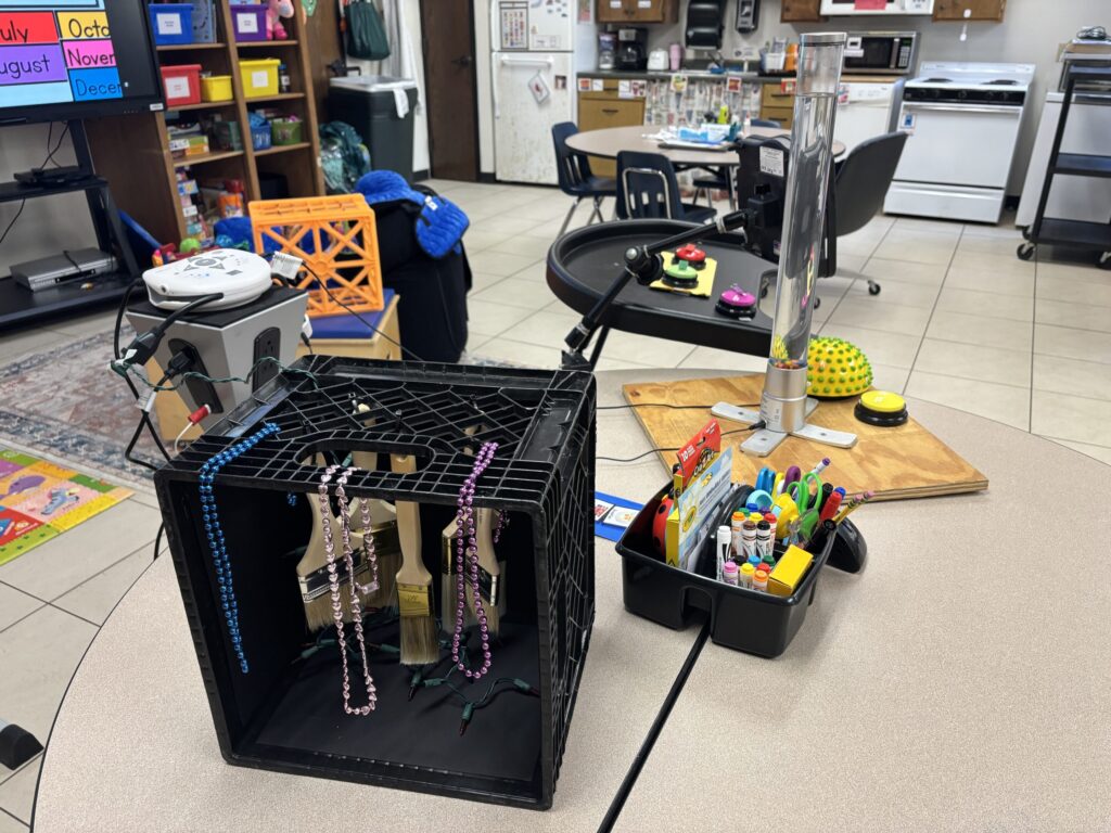 Switches and sensory crates are shown on a table, attached to an able net Powerlink4.