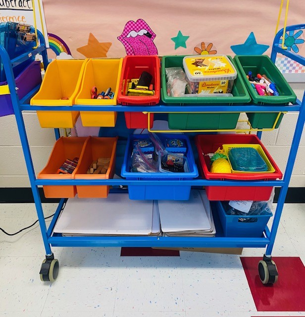 A cart with colorful bins full of school supplies