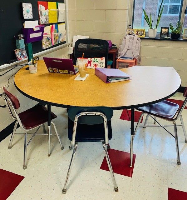 A kidney-shaped table in a classroom